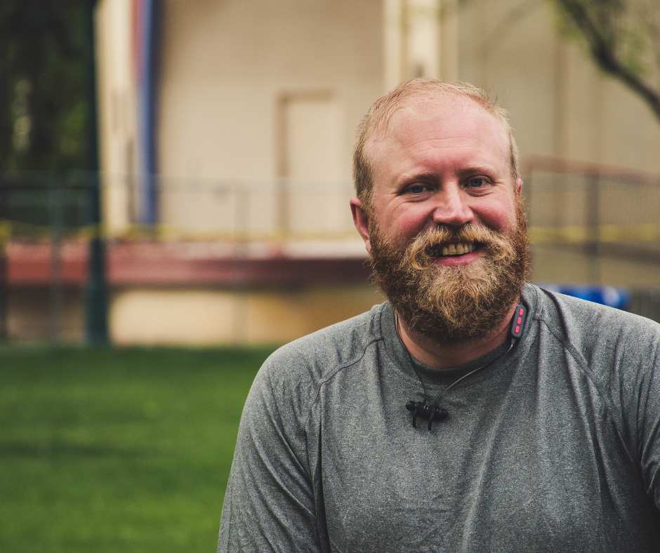 A while man with a red hair and a beard smiling. Community Housing provides a safe, permeant home for people who experienced homelessness