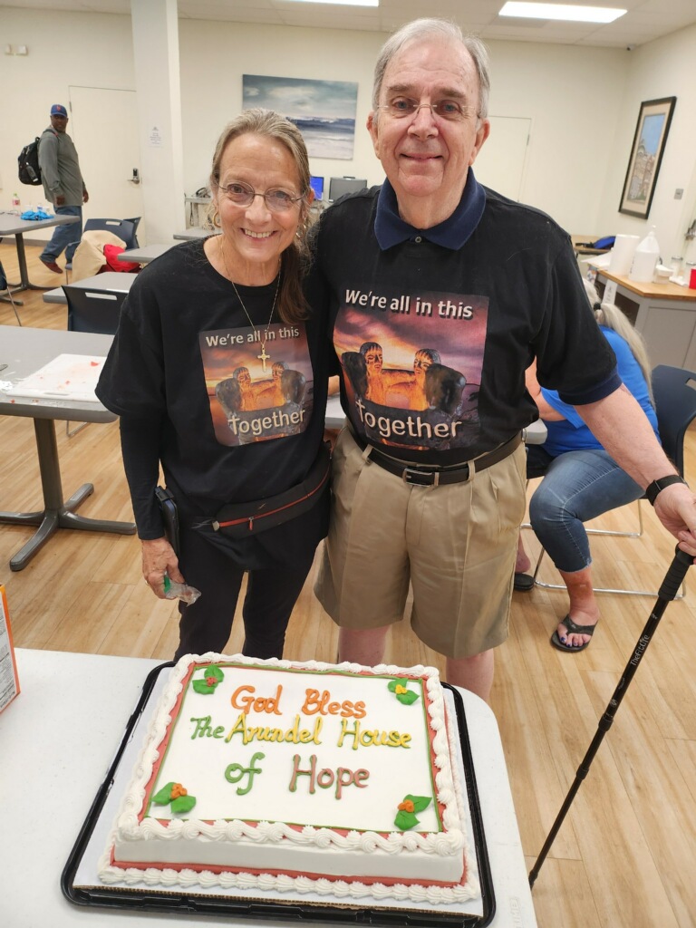 Man and women standing near a cake